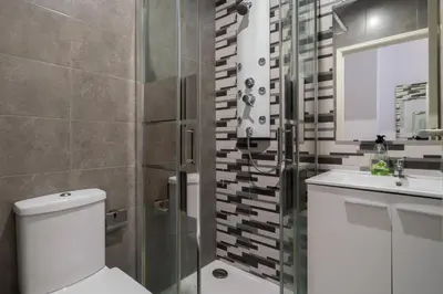 a bathroom with a toilet and a sink and a shower at Moreira Family in Porto