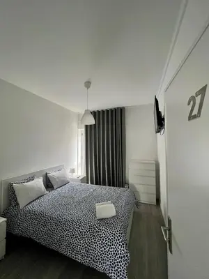 a bedroom with a bed with a black and white cheetah print at Moreira Family in Porto