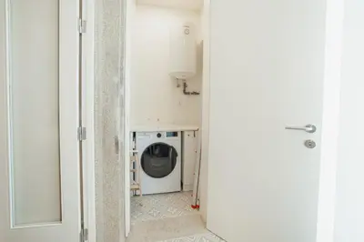 a laundry room with a washing machine in a hallway at Home With a Pool by Vacationy in Porto