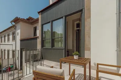 a patio with a table and chairs on a balcony at Home With a Pool by Vacationy in Porto