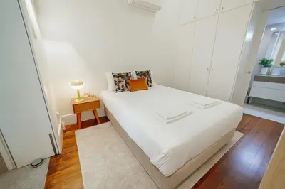 a bedroom with a large white bed in a room at Home With a Pool by Vacationy in Porto