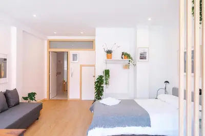 a living room with a bed and a couch at Porto serenity studio in Porto