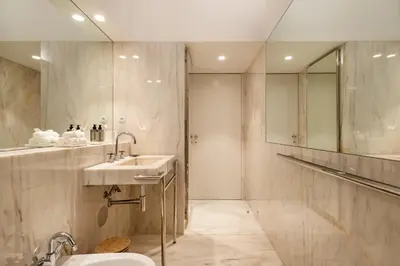 a bathroom with a sink and a mirror at Clerigos 82 luxury Housing in Porto