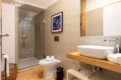 a bathroom with a sink and a toilet and a shower at BmyGuest Collection - The Marquis Luxury Garden Apartment in Porto