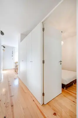 a bedroom with a white closet and a bed at VIVA Bonfim Cozy Home in Porto