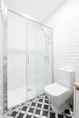 a bathroom with a toilet and a glass shower at VIVA Bonfim Cozy Home in Porto