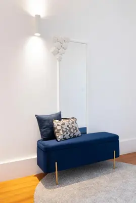 a blue couch in a living room with a rug at Historical Penthouse at Cardosas Block in Porto