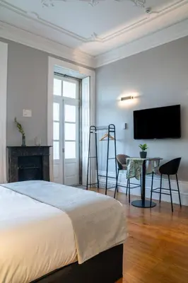 a bedroom with a bed and a table and a television at Limehome Porto Rua de Dom Manuel II in Porto