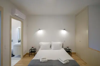 a bedroom with a large white bed with two towels on it at Mártires Sweet Apts by PortoCityHosts in Porto