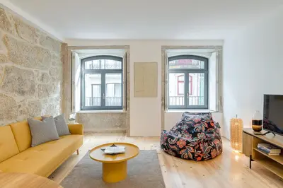 a living room with a couch and a table at Alma da Casa by DA'HOME in Porto
