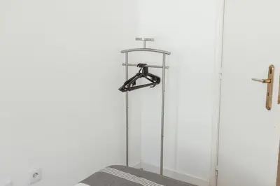 a glass shower stall with a cross on the wall at Pateo In Lapa City Center by Vacationy in Porto