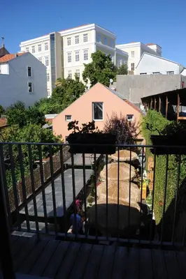 a man sitting on a balcony looking at a building at Capim Dourado Apartments Cedofeita in Porto