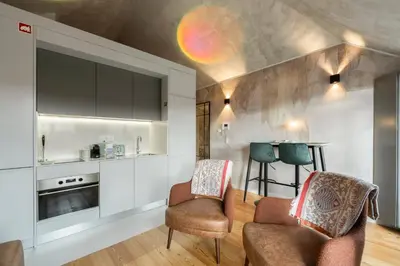 a kitchen with two chairs and a table at GuestReady - Elegant living in Porto city centre in Porto