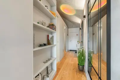 a hallway with white walls and wooden floors at GuestReady - Elegant living in Porto city centre in Porto