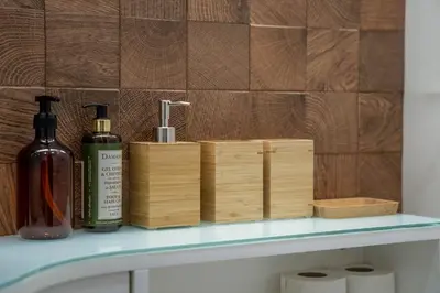 a shelf with two bottles of soap and wooden boxes at João IV Jewel Retreat by LovelyStay in Porto