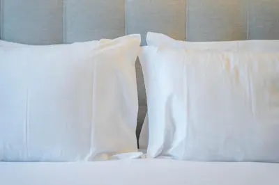 two white pillows sitting on top of a bed at João IV Jewel Retreat by LovelyStay in Porto