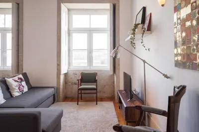 a living room with a couch and a chair at Santo António Loft - Porto Perfect in Porto