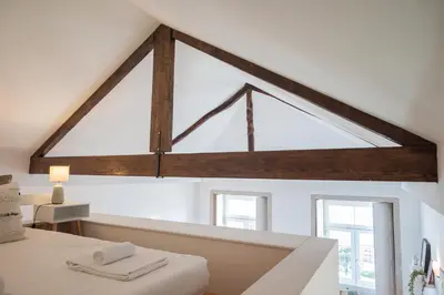 a large window in a room with a bed at Santo António Loft - Porto Perfect in Porto