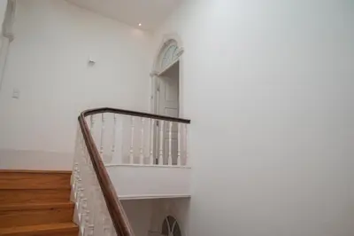 a staircase in a house with white walls and wooden floors at Santo António Loft - Porto Perfect in Porto