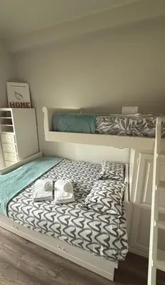 a bedroom with two bunk beds and a ladder at Acquamarina Porto in Porto