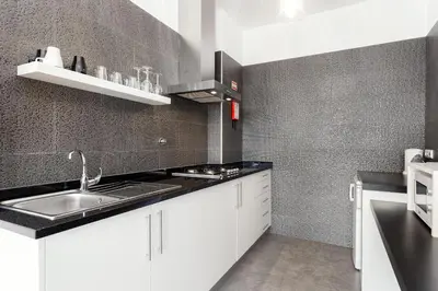 a kitchen with white cabinets and a sink at Belly Angel Apartment in Porto