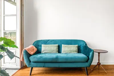 a blue couch in a living room with a table at Belly Angel Apartment in Porto