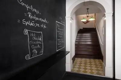 a hallway with a chalkboard wall with a stair case at Hungarian Biscuits Historic Center in Porto
