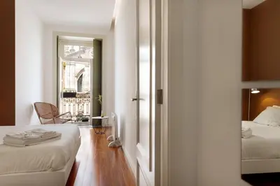 a hotel room with two beds and a window at Hungarian Biscuits Historic Center in Porto