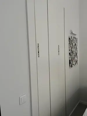 three white lockers in a room with a picture at JM Alojamento local no Porto in Porto