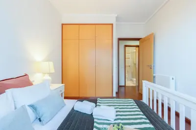 a small bedroom with a bed and a staircase at Host Wise - Gorgeous Spacious Flat - Ace Location in Porto