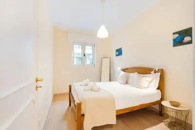 a small bedroom with a bed with white sheets at GuestReady - A pleasant stay in Porto in Porto