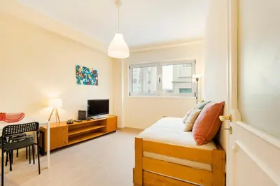 a bedroom with a bed and a desk with a television at GuestReady - A pleasant stay in Porto in Porto