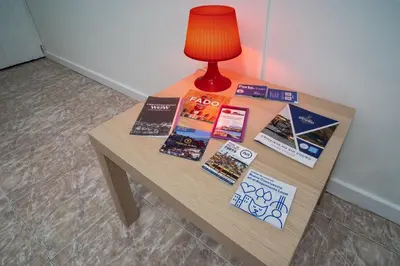 a table with books on it with a lamp on it at OPO Domus in Porto