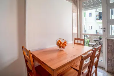 a wooden table with a bowl of fruit on it at OPO Domus in Porto