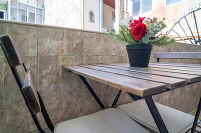 a wooden table with a vase of flowers on it at OPO Domus in Porto