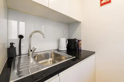 a stainless steel sink in a small kitchen at GuestReady - King House 2 in Porto