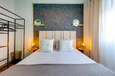 a bedroom with a bed and a large window at Quiet Point in Porto
