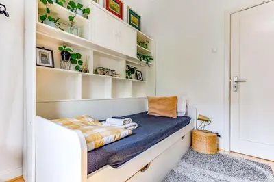 a room with a couch and shelves with plants at Quiet Point in Porto