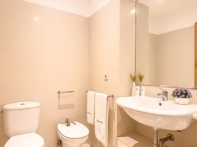 a white bathroom with a sink and a toilet at Host Wise - Comfy Charming Flat w Netflix - Ace Location in Porto