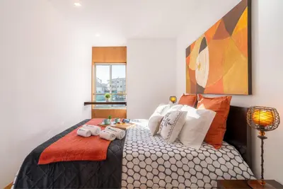 a bedroom with a bed with towels on it at Host Wise - Comfy Charming Flat w Netflix - Ace Location in Porto