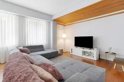 a living room with a couch and a flat screen tv at Apartment Boutique Santa Catarina 2 in Porto