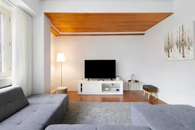 a living room with a couch and a flat screen tv at Apartment Boutique Santa Catarina 2 in Porto