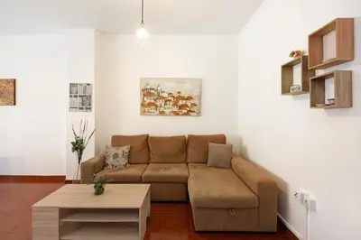 a living room with a couch and a table at Trindade Porto City Centre in Porto