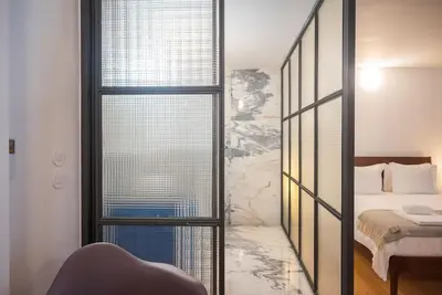 a living room with a couch and a kitchen at Charmy Studio Porto in Porto