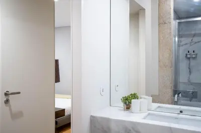 a bathroom with a sink and a mirror at Primrose 1BR Delight w Parking by LovelyStay in Porto