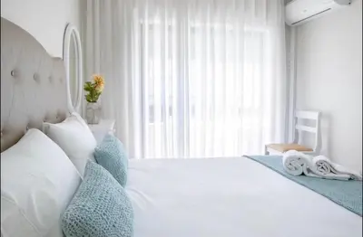 a bedroom with a white bed with blue pillows at Belas Artes Apartment by LovelyStay in Porto