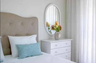 a bedroom with a bed with a mirror and a dresser at Belas Artes Apartment by LovelyStay in Porto