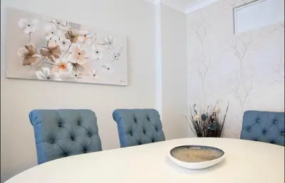 a dining room with a table and blue chairs at Belas Artes Apartment by LovelyStay in Porto