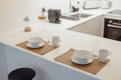 two cups and two saucers on a kitchen counter at OPORTO GUEST Renovato Luxus Flat w/ parking in Porto