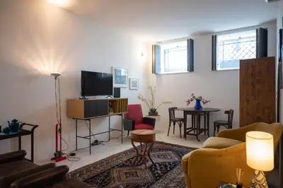 a living room with a couch and a tv at Touchy Porto in Porto